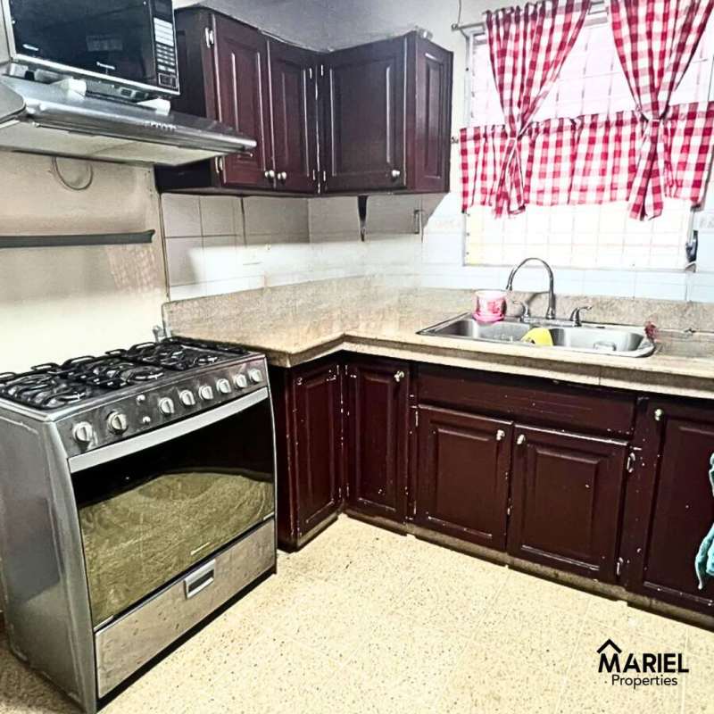 Traditional kitchen with cabinets, microwave, stove in Lomas del Golf Panama City