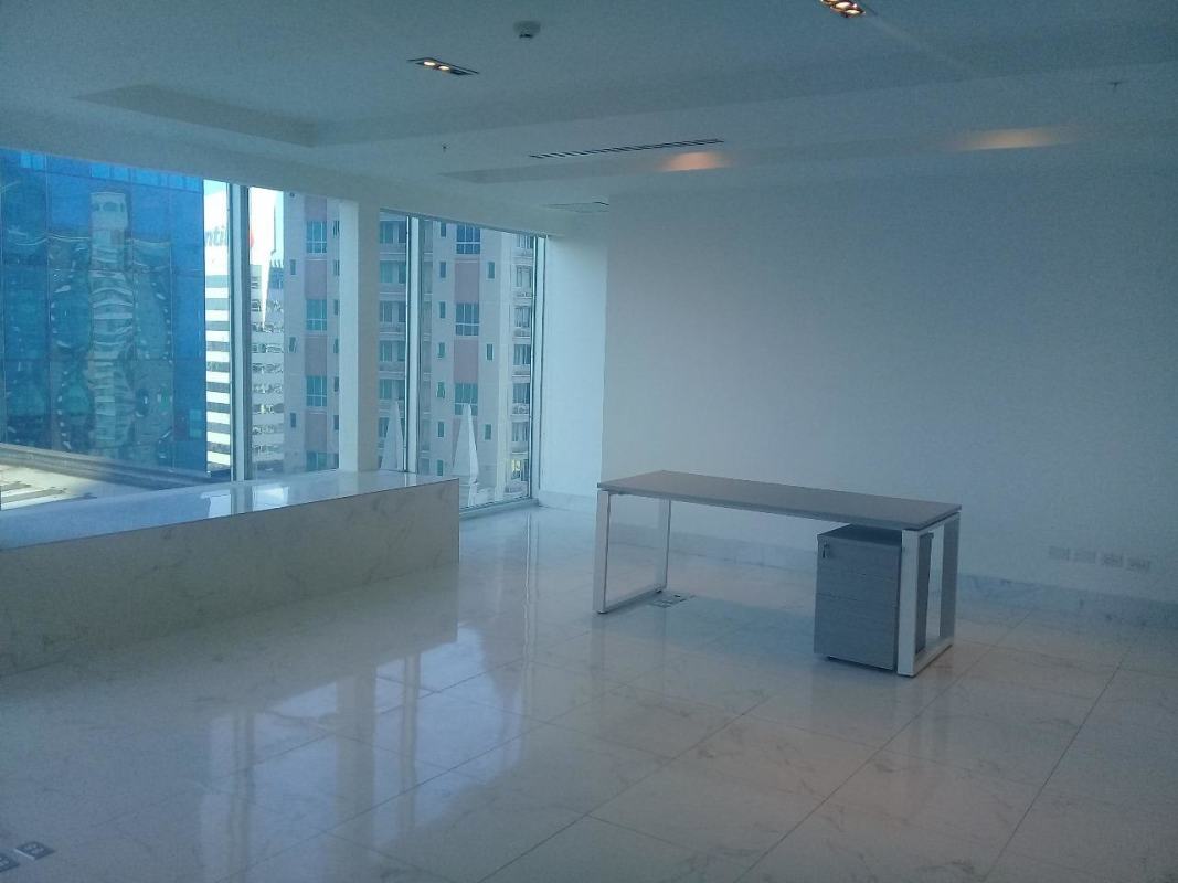 Empty minimalist office space with marble flooring, large windows overlooking city skyline in Punta Pacífica Panama