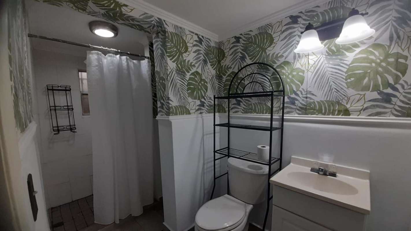 Bright secondary bedroom with queen bed, closet and window Clayton Park Residences