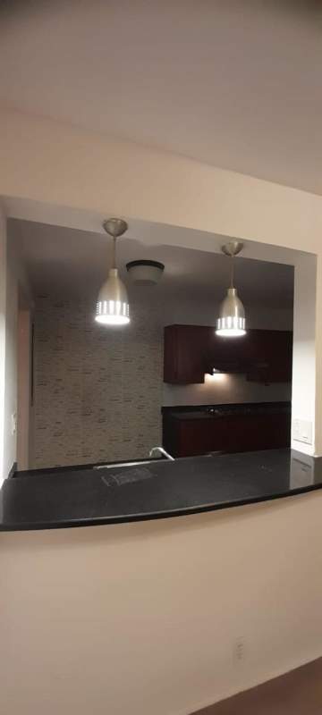 Kitchen with Italian tile floors, appliances and double refrigerator in ground floor Clayton apartment