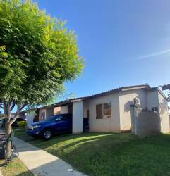 Living room with beige sofas, striped rug, wall art and entertainment console in Álamos Arboledas Panama