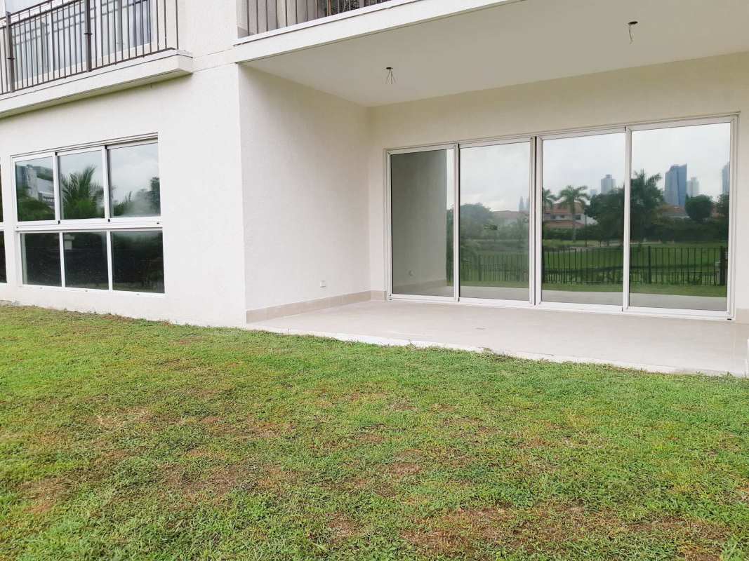 Spacious marble-floored living area with sliding glass to terrace and garden view in The Reserve Santa Maria