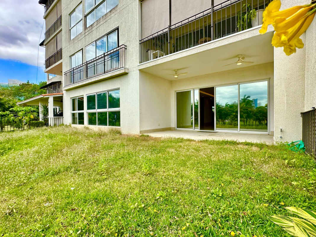 Modern closed kitchen with marble countertops and wood cabinetry The Reserve Santa Maria Panama