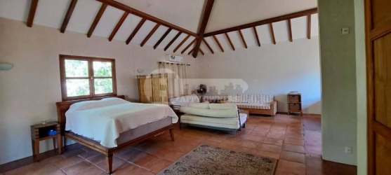 Rustic vaulted bedroom with beams and balcony in Ocean Lofts Destiladeros Pedasí Panama