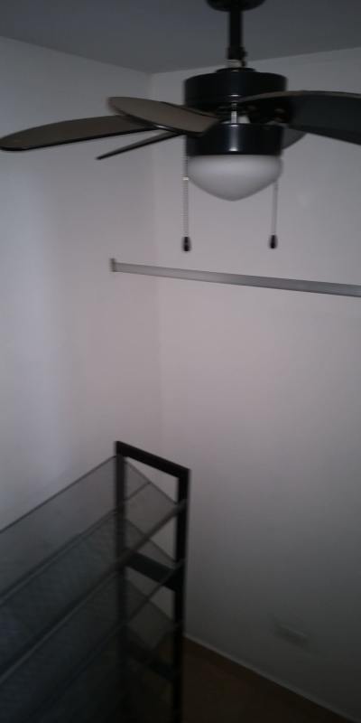 Small walk-in closet with fan and storage PH Transistmica Panama City