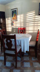 Bedroom features tile floor, wood bed frame, ceiling fan for rent Las Tablas Panama