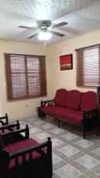 Traditional living space with wood furniture, tiled floor, ceiling fan for house rental in Las Tablas