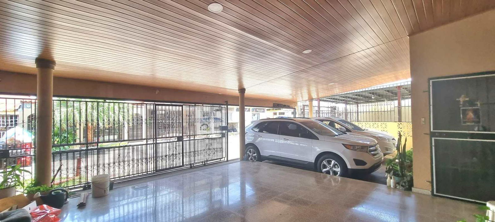 Covered parking with metal gate at residential home in Altos del Hipódromo Panama City