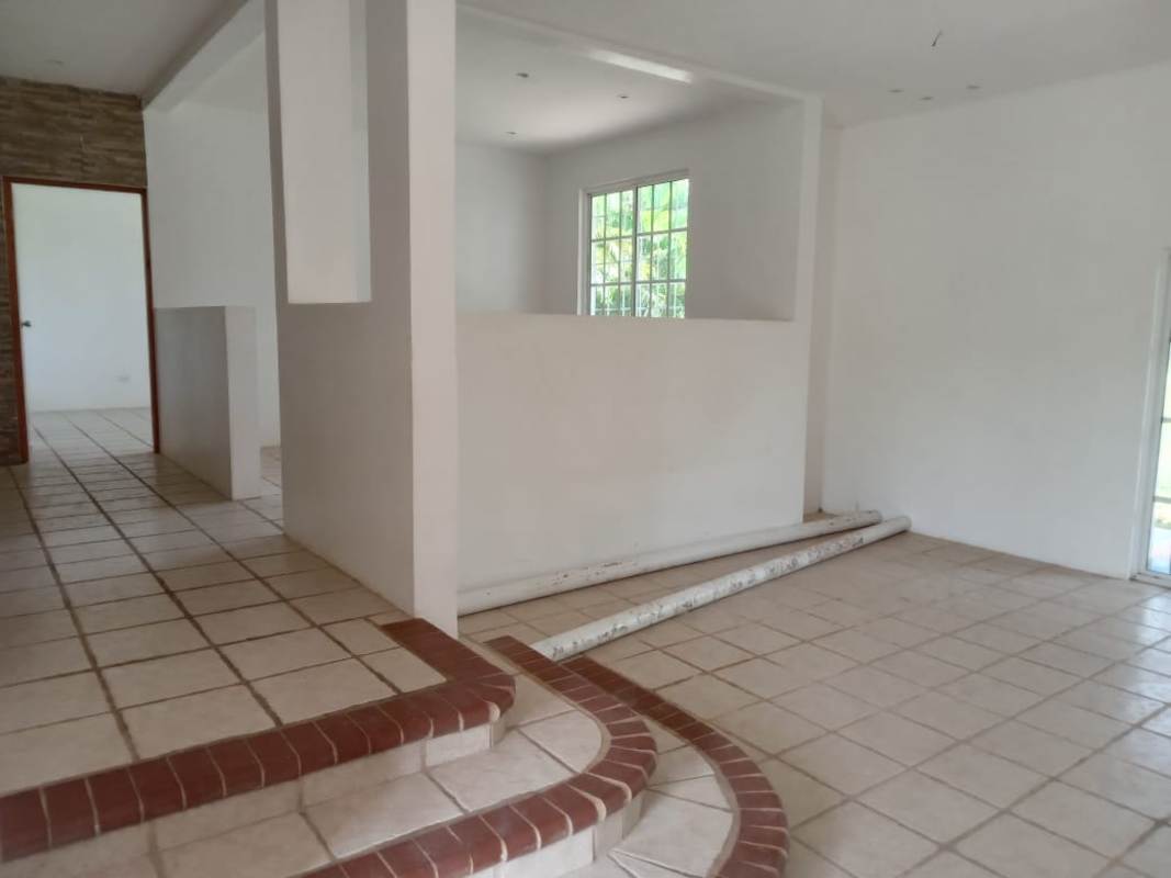 Renovated kitchen with large window, black and wood cabinetry, granite countertop in Cerro Azul Panama