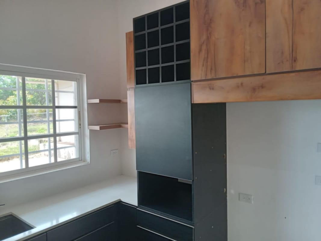 Modern kitchen with white countertops, wood shelves, wine rack in Hacienda Country Club Panama