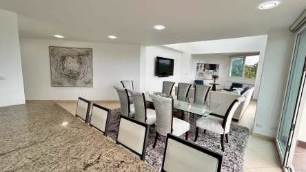 Spacious bedroom suite with large windows and ensuite bath in Eagles Landing Penthouse