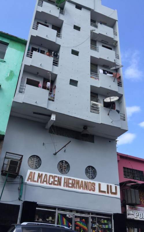 Apartment entrance with red wooden door and black metal security grill for rent PH Avenida B Santa Ana Panama City