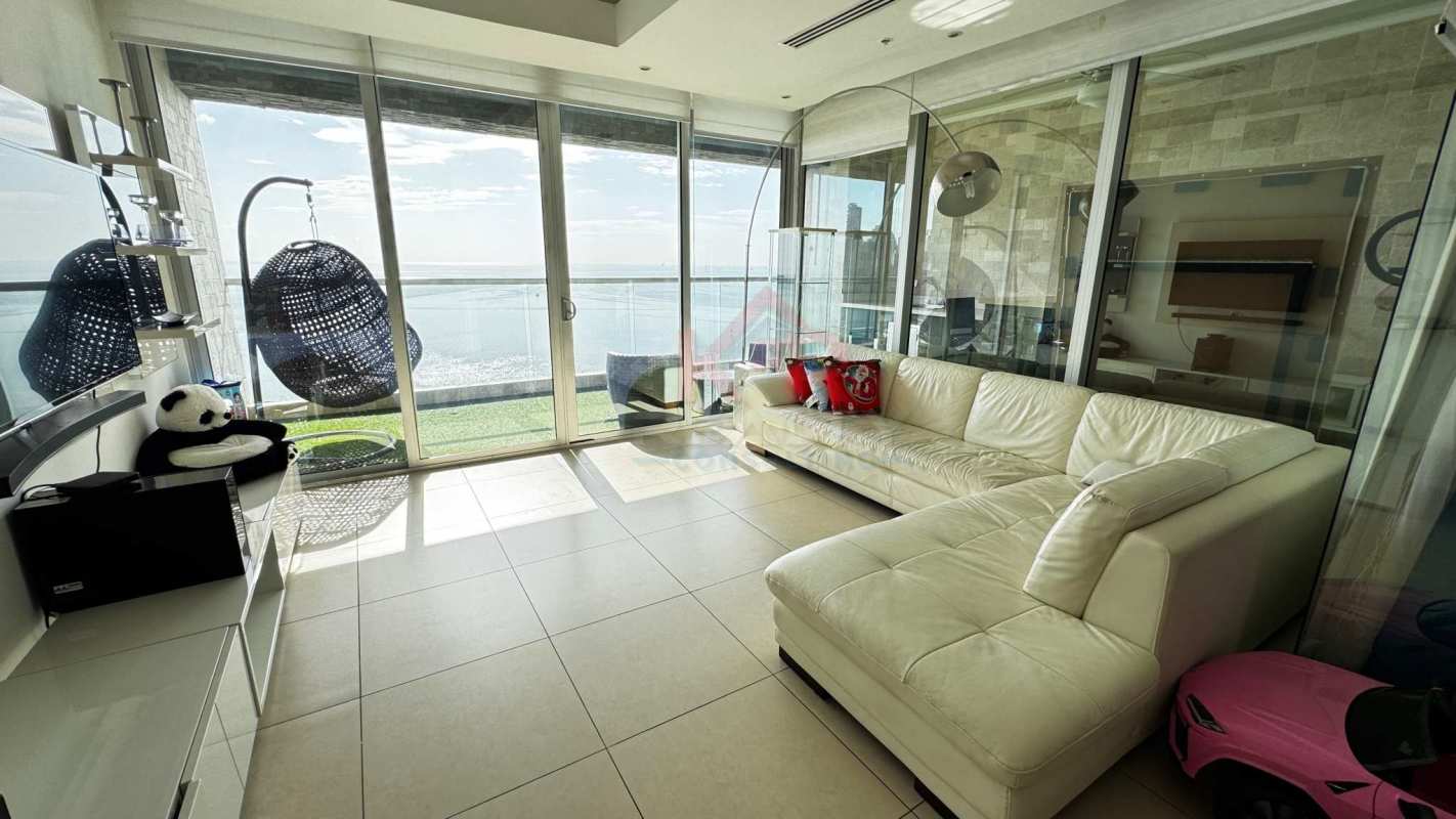 Spacious living room with large glass doors to oceanfront balcony Avenida Balboa Panama