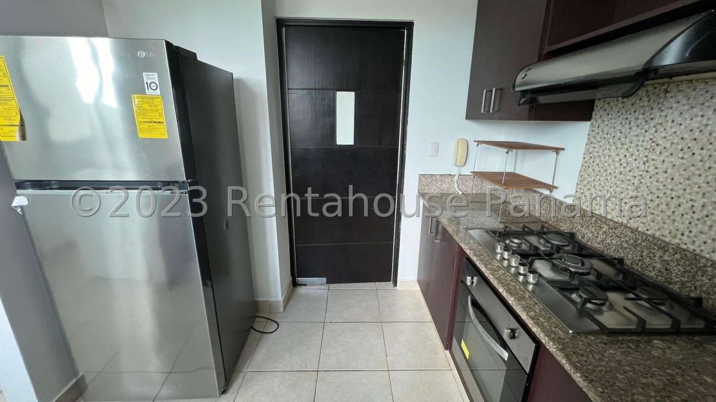 Kitchen with granite countertops, stainless refrigerator, oven, and mosaic backsplash at PH Albrook Court Panama