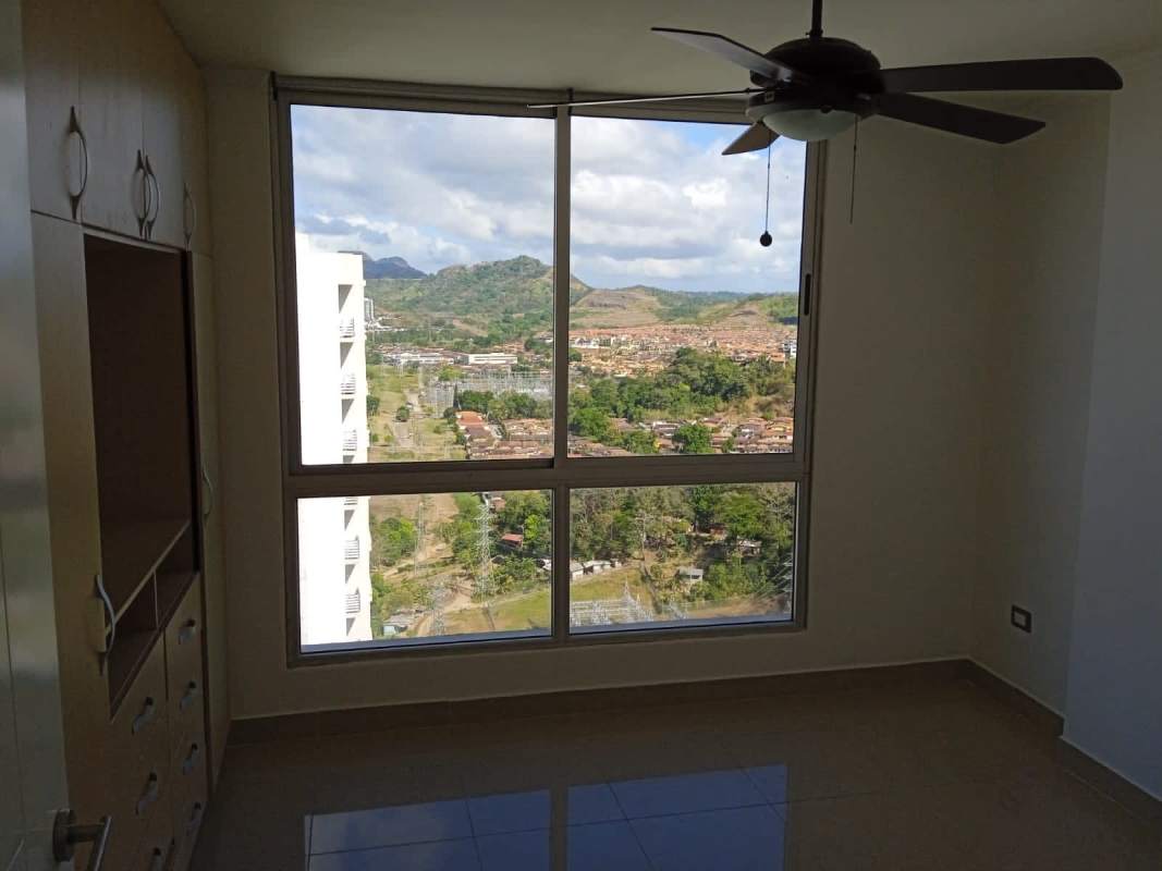 Bedroom with ceiling fan, wardrobe and city mountain view in Edificio Rokas Panama