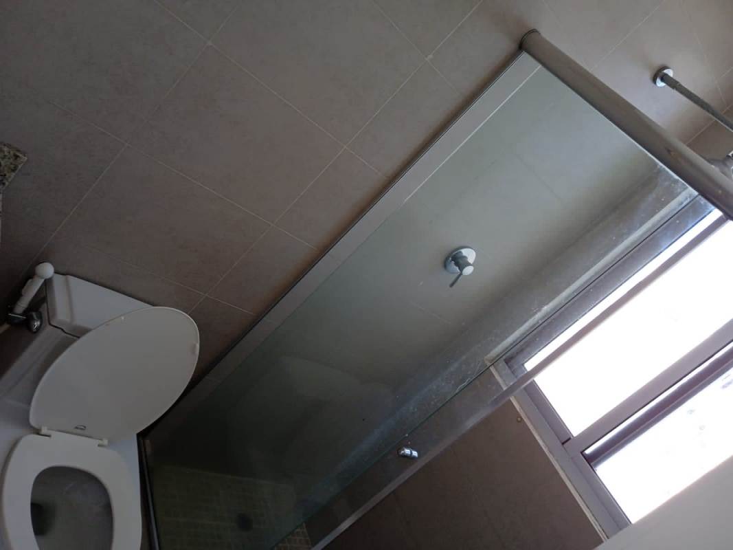 Modern bathroom with glass shower and window at Edificio Rokas Condado del Rey