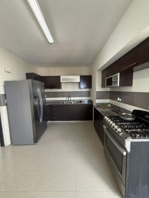 Kitchen with granite countertops and stainless appliances in PH Infinity Tower San Francisco Panama