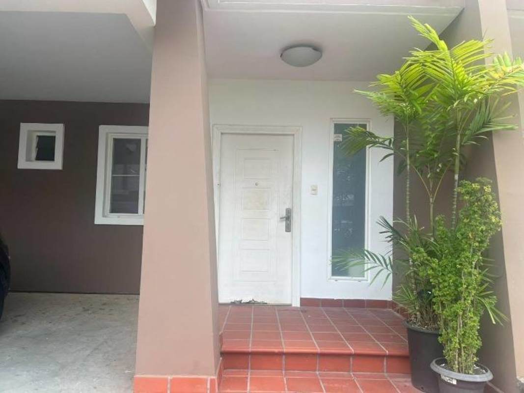 Modern two-story townhouse facade with carport PH Everest Brisas del Golf