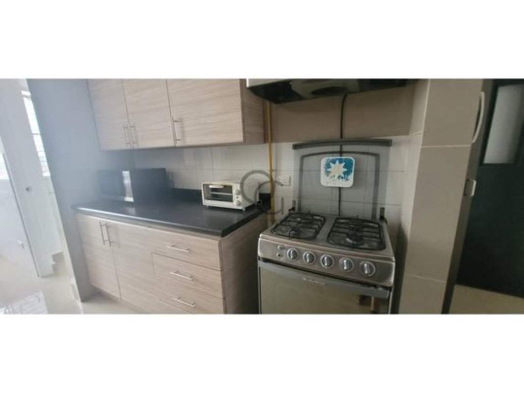 Modern kitchen with appliances, granite countertop, cabinetry in Panama apartment