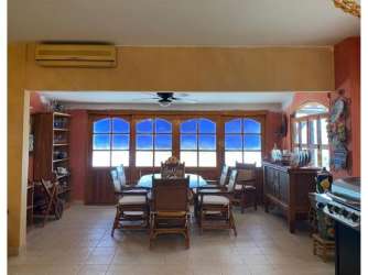 Dining room with panoramic ocean view, wooden dining set and tile floor in Marina del Rey duplex