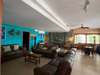 Bright open kitchen with wood cabinetry and living room in Playa Blanca beachfront property