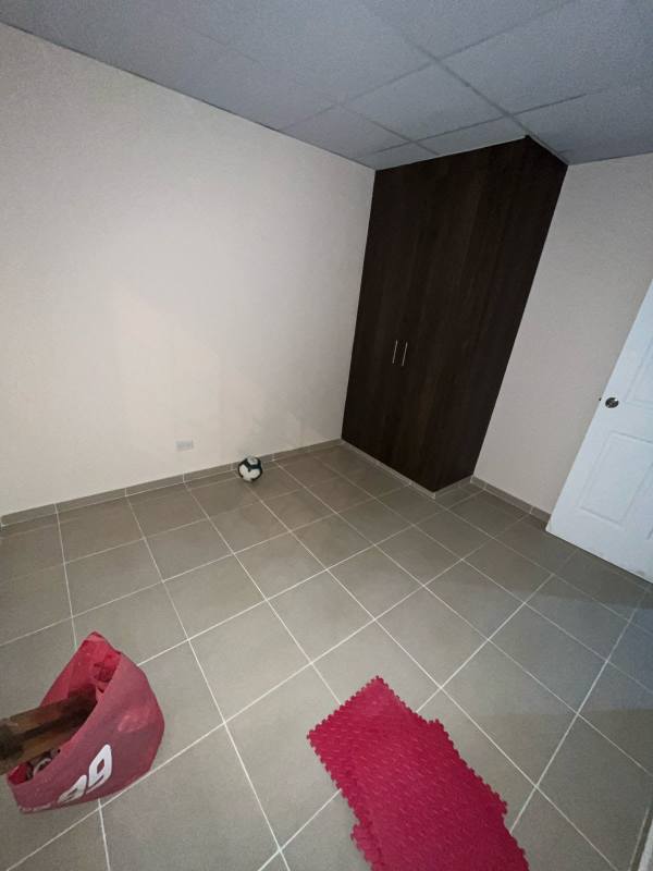 Bedroom with tiled floor, dark wood wardrobe in Villa Grecia Las Cumbres