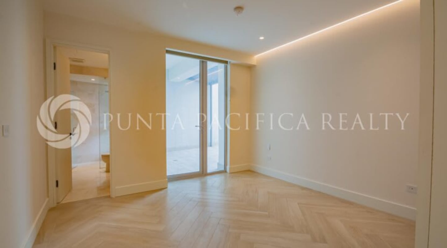 Spacious bedroom with balcony access, floor-to-ceiling windows at Beach Club Residences Ocean Reef Island Panama