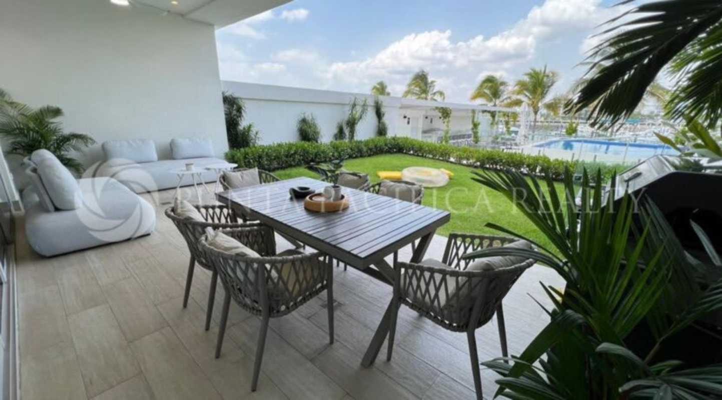 Spacious living room with luxury furnishings and water views in Ocean Reef condo Panama City