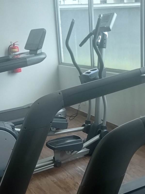 Modern gym with exercise equipment, treadmills and large windows at Residencial San Francisco Panama City