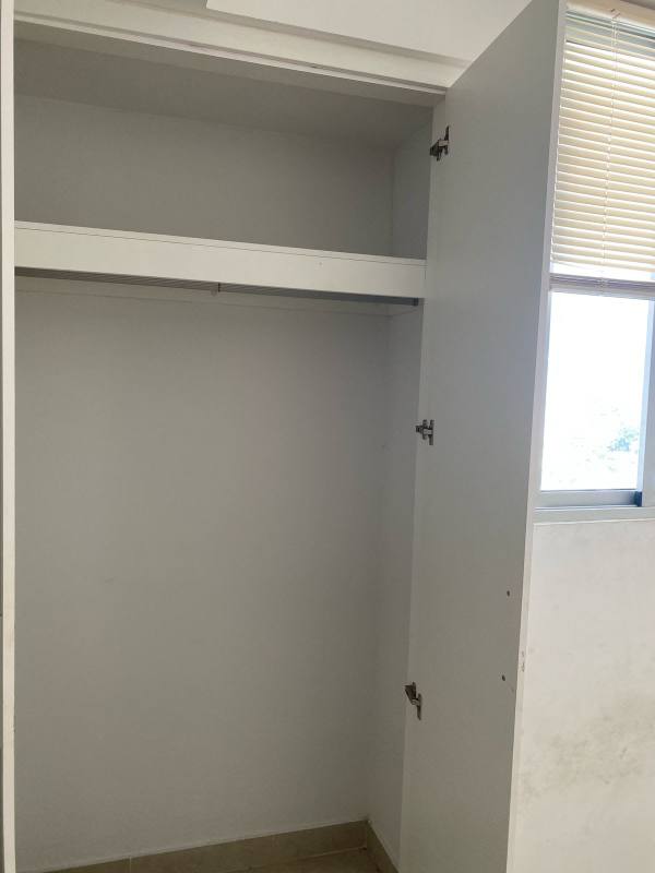 Minimalist bathroom with pedestal sink, toilet, mirror, and walk-in shower in rental apartment Panama