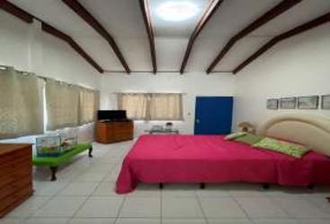 Large bedroom vaulted ceilings exposed beams and Caribbean decor Isla Grande Panama