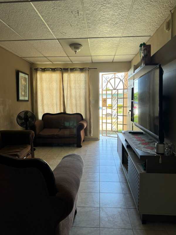 Traditional living room with tiled floor in Villas de Don Bosco affordable home Panama