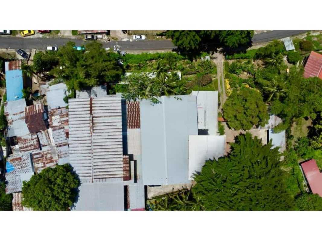 Aerial shot commercial property with metal roofs surrounded by green area Panama City