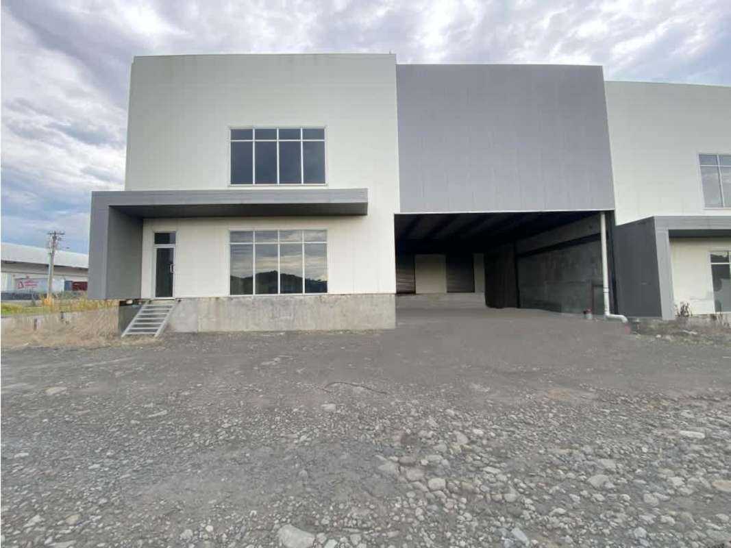 Modern industrial warehouse building with large windows and covered loading dock in Villa Zaita Panama