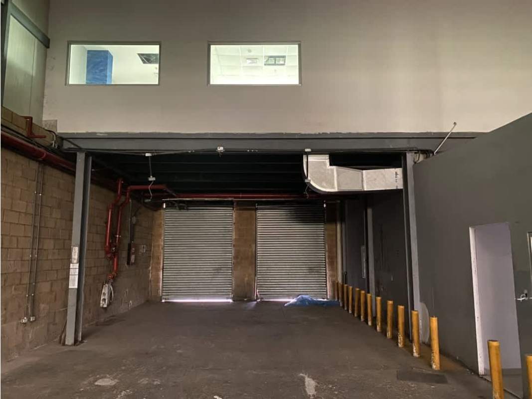 Interior warehouse with roll-up doors concrete walls cinder block and bollards at Villa Zaita Business Park Panama
