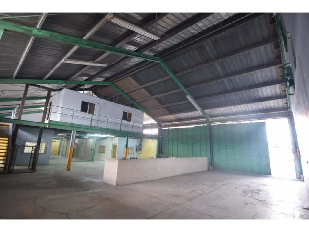 Interior of industrial warehouse with high ceilings, mezzanine office, large open floor, concrete and steel beams in Panama City