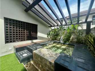 Spacious living room with large windows, high ceilings and natural light at PH Nativa Panama Pacifico
