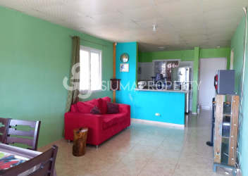 Bright kitchen area with green walls, refrigerator, tiled backsplash in Arraiján El Edén
