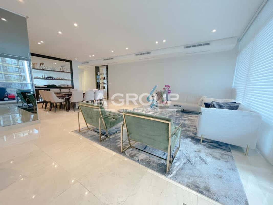 Large open-plan living and dining area with floor-to-ceiling windows and marble floors in Aventura Tower Punta Paitilla Panama