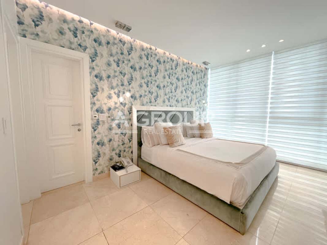 Modern bedroom with floral accent wall and large window in Aventura Tower Punta Paitilla Panama