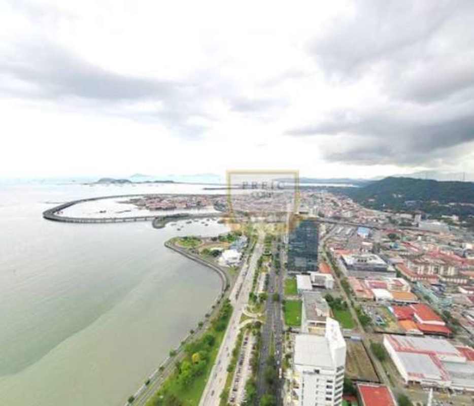 Bright living room with floor-to-ceiling glass to balcony and panoramic ocean views in PH Rivage Panama