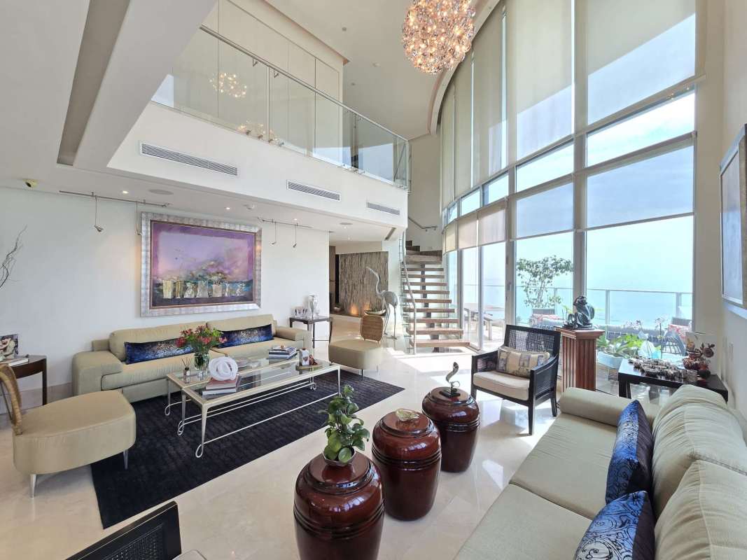 Double-height penthouse living room with panoramic ocean views in Blue Bahía Punta Pacifica