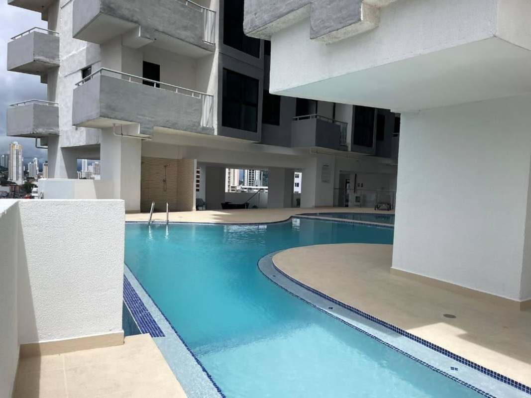 Compact kitchen with granite counters, stove, fridge, microwave in PH Worldwide Plaza Panama