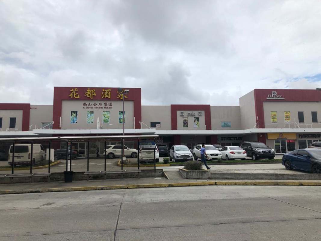 Commercial retail plaza exterior with stores signs parking lot in Brisas del Golf Panama