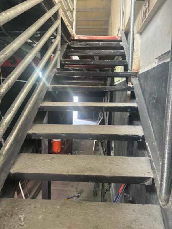 Metal stairs unfinished cement inside commercial plaza space Brisas del Golf Panama