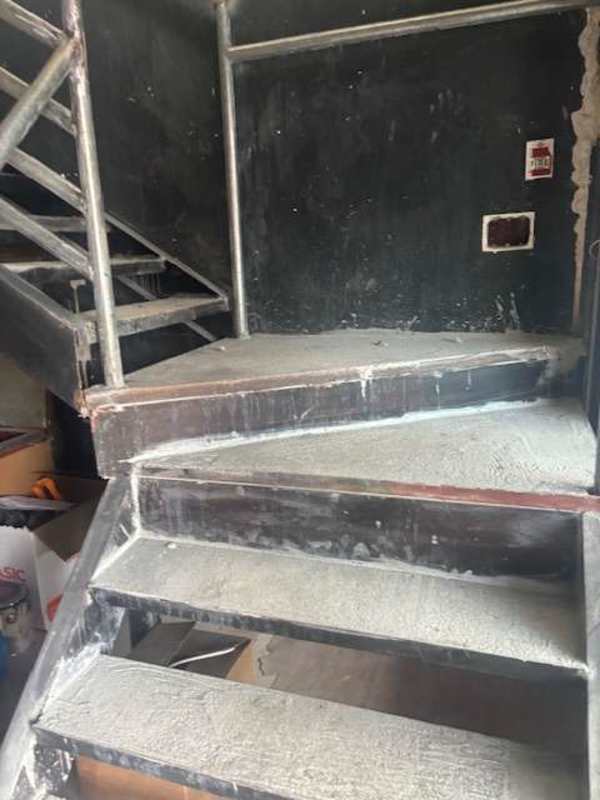 Unfinished interior stairs with metal handrails in commercial warehouse style unit Brisas del Golf Panama