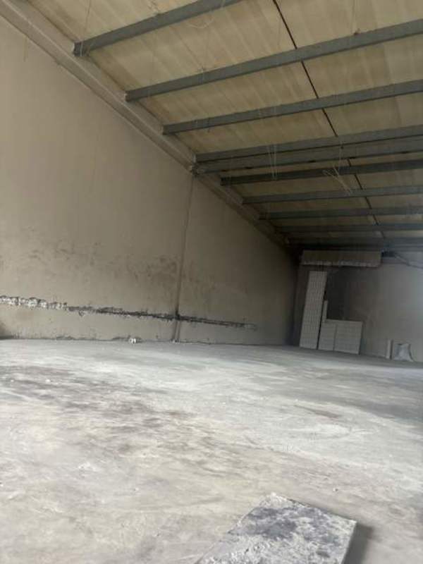 Industrial stairwell with unfinished walls and metal railings inside commercial unit Brisas del Golf Panama