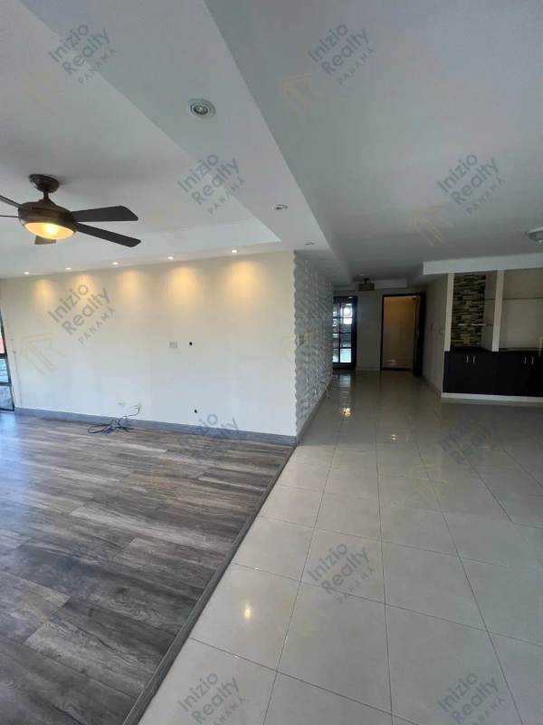 Renovated bathroom with glass shower enclosure and tile walls Panama City apartment