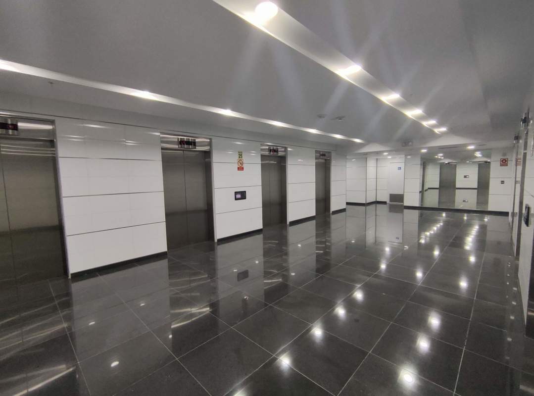 Modern elevator hall with glossy tile floors and multiple elevators at Oceania Business Plaza Panama
