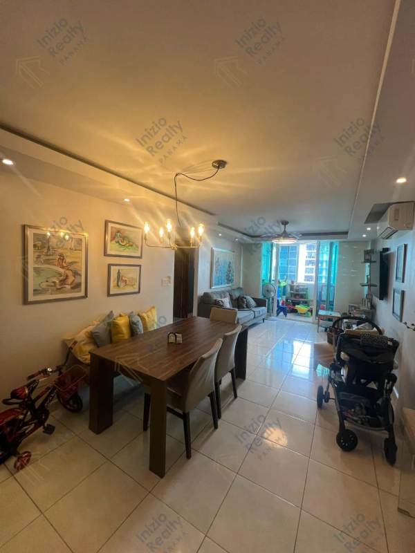 Open plan living dining area with large window city view, bright interior, in El Cangrejo Panama apartment